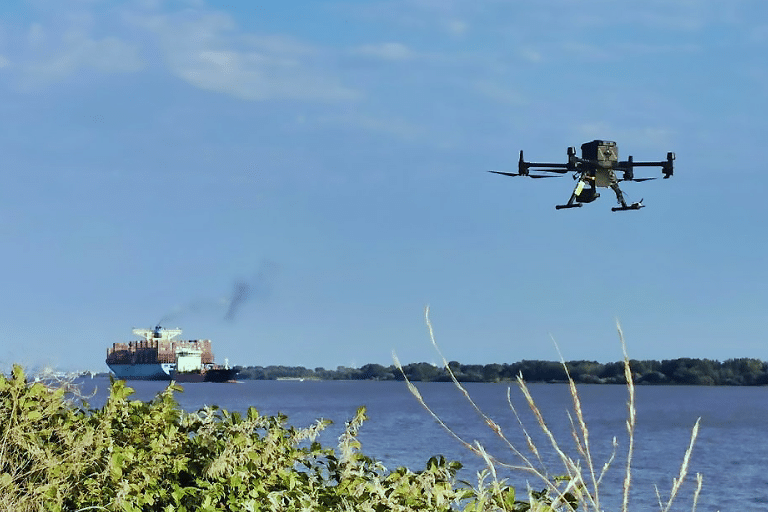 Cargo ship with Explicit drone conducting maritime sulphur and greenhouse gas emissions monitoring